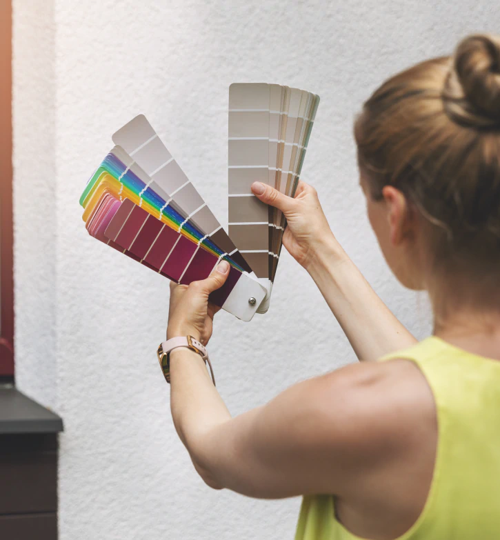 woman choosing paint color for house exterior