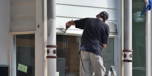 worker painting the office exterior